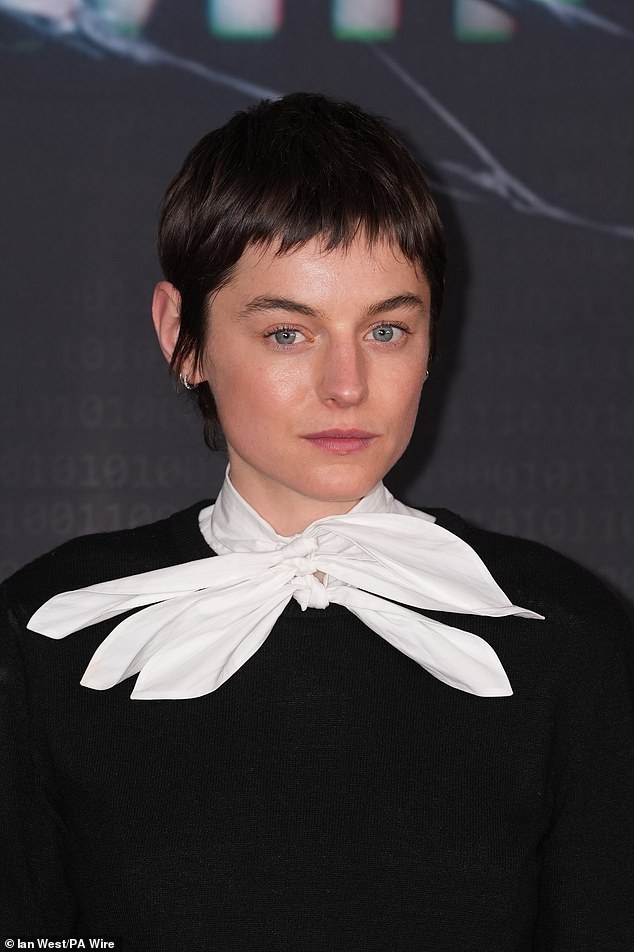 Emma looked chic in a black jumper and white neck tie