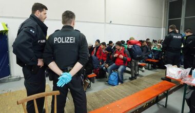Migrants and refugees arriving from Austria wait to be registered at a processing centre in Germany