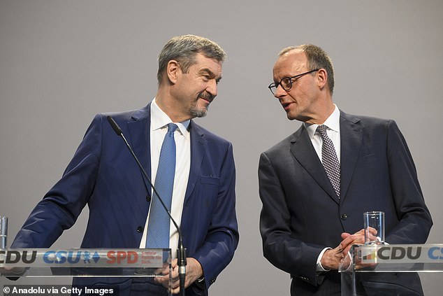 Friedrich Merz (R), leader of the Christian Democratic Union (CDU), Markus Soder (L), leader of the Christian Social Union (CSU), speak ahead of their agreement of a coalition with the SPD