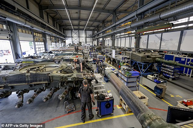 Technicians of German armaments company and automotive supplier Rheinmetall assemble a Leopard 2A4 battle tank