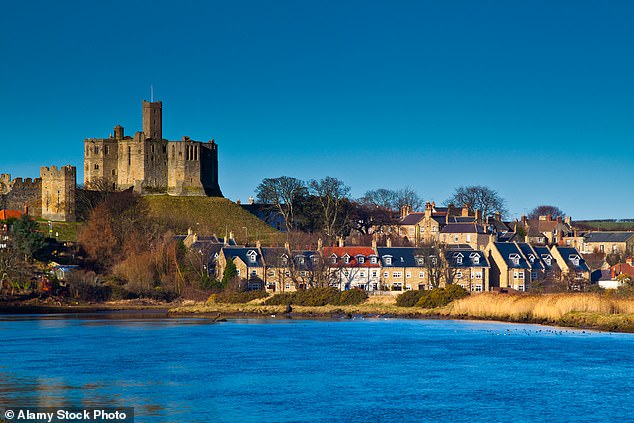 Warkworth Castle, a 12th-century stone motte and bailey fortress, overlooks the village of Warkworth in Northumberland