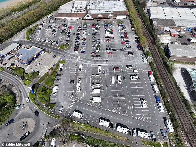 Aerial pictures show 19 caravans parked across several spaces in the carpark alongside several vans and cars