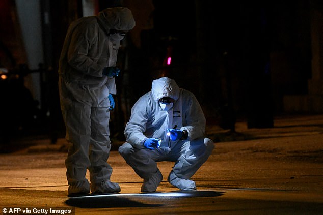 Greek Police experts search for evidence after a bomb explosion outside the Athens offices of Hellenic Train in Athens