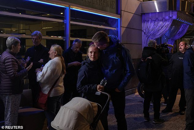 Tourists and residents gathered in nearby streets after being evacuated outside following the anonymous calls ahead of a bomb blast