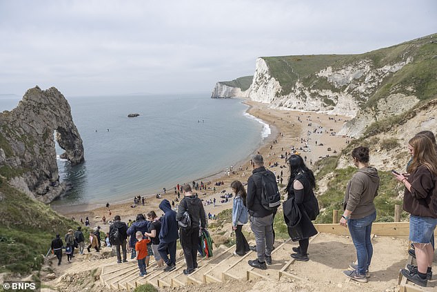 Crowds were seen flocking to the picturesque Durdle Door on a week of warm sunshine and blue skies in Dorset