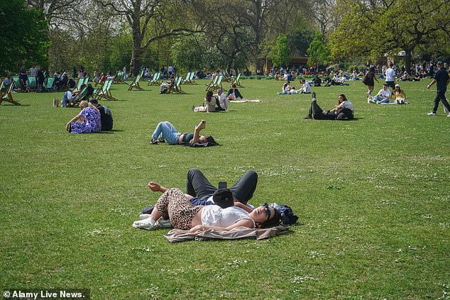 People enjoying the spring sunshine in St James's Park in London today
