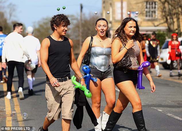 People are seen enjoying the sunshine for the Otley Run in Leeds
