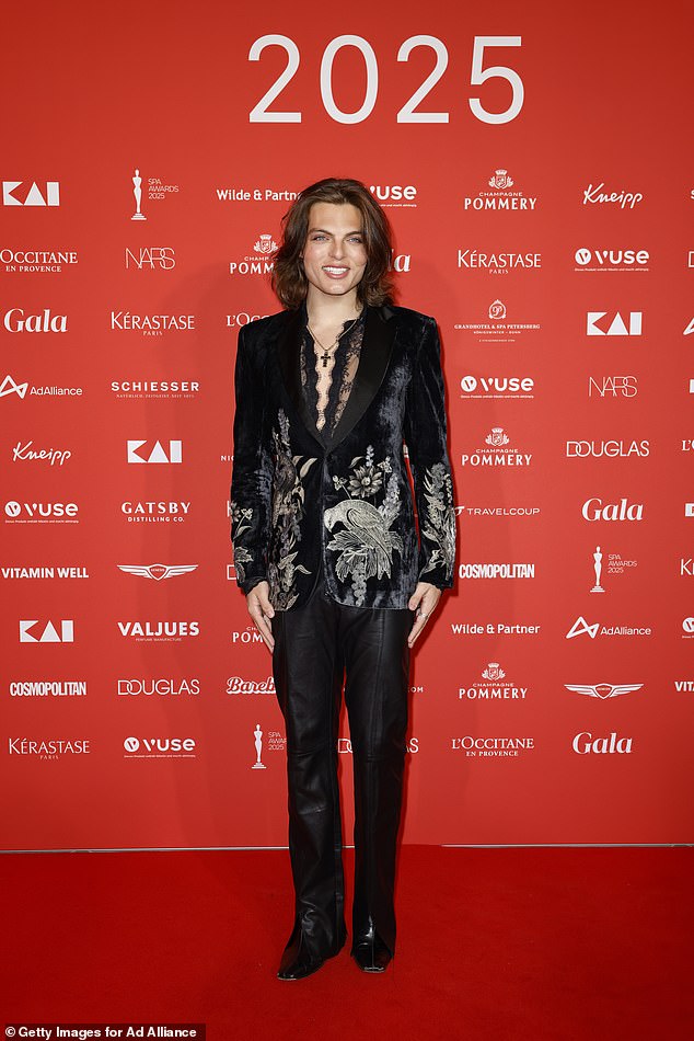 Meanwhile, Damian cut a dapper figure in a stylish floral blazer and leather trousers, teamed with heeled boots