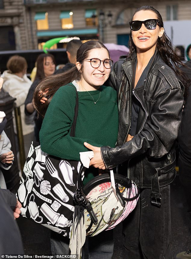 The model showcased her toned physique in a cropped black top which she layered under an oversized black leather jacket