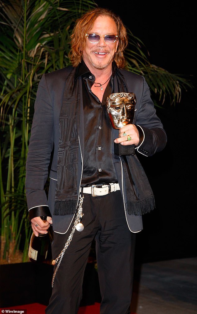 Mickey posing at the winner's board at The Orange British Academy Film Awards in 2009, with an eccentric hair style