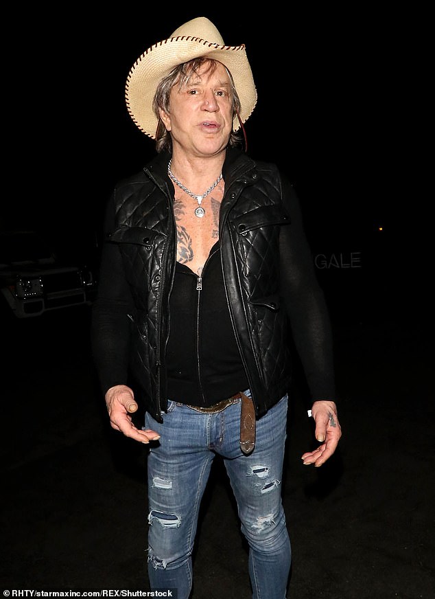 Sometimes Rourke donned a brown wig with blonde highlights and usually hidden under a cowboy hat. Pictured in 2018