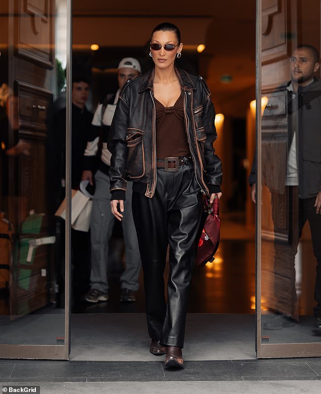 Bella later changed into a brown top and leather trousers as she exited the Ritz Hotel
