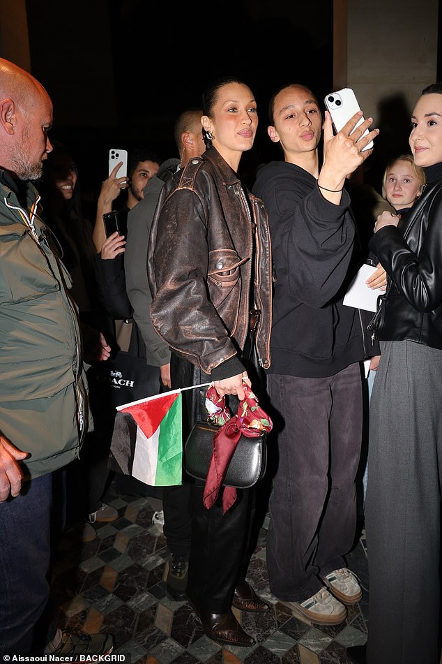 Bella, who is Palestinian, was seen carrying a Palestine flag as she headed out in Paris on Sunday