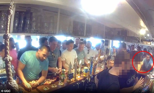 Meanwhile, there were chaotic scenes inside a packed village pub in Surrey on Saturday afternoon, with a man (circled) seen grabbing bottles from behind the bar