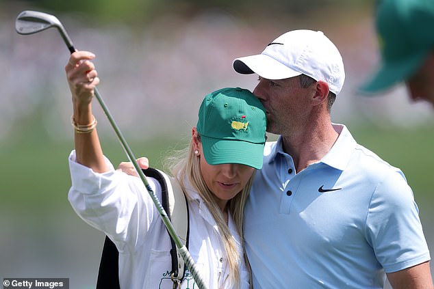 Rory kisses wife Erica during the Par Three Contest prior to the 2025 Masters Tournament at Augusta National Golf Club on Wednesday