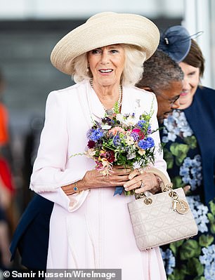 The Queen at Ascot with her £5,000 Lady Dior handbag by Christian Dior