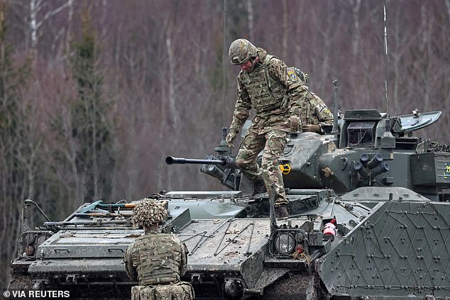Prince William is pictured getting off a Challenger 2 battle tank while attending a field training session on his visit to a Nato base in Estonia last month
