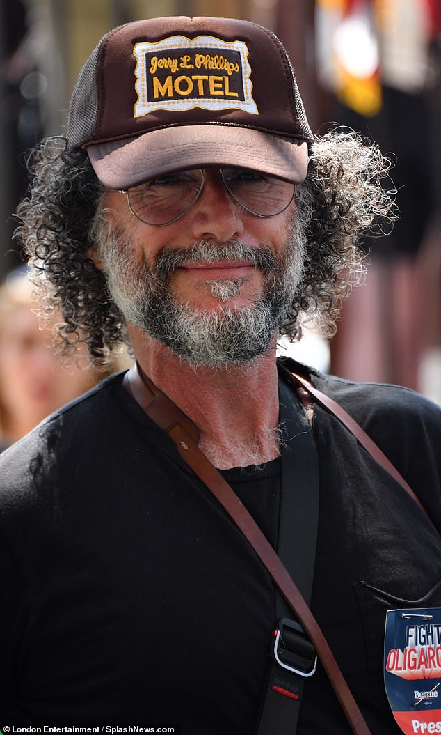 He brandished a press badge as he took various photos of the event
