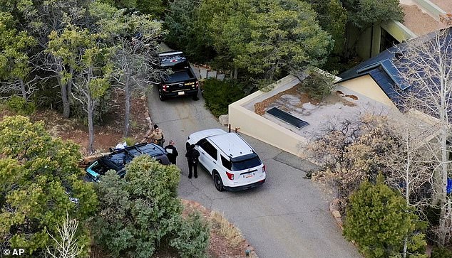The family farewell comes after Hackman and his wife's bodies were discovered in their Santa Fe home on February 26; police are pictured outside the house on February 27