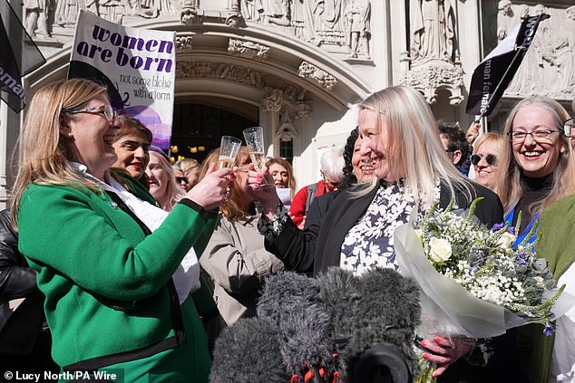 The judgement was celebrated by women's rights groups who opened a bottle of champagne. Pictured: Susan Smith (centre left), Marion Calder (centre right) and Helen Joyce (right)