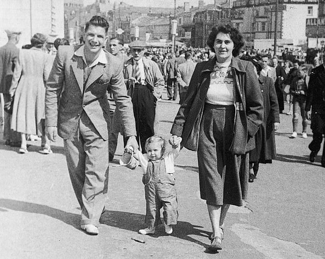 Jenni Murray as a baby with her parents in 1951. Her father confided in her how hard school was for him