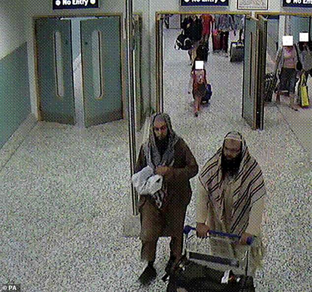 Irfan Khalid pictured arriving at Birmingham airport with his co-conspirator, Irfan Naseer