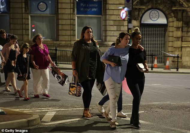 Police escorting members of the public from the Manchester Arena
