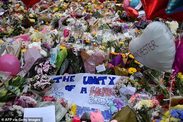 A carpet of flowers and messages at St Ann's Square in Manchester following the attack