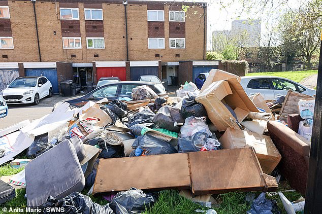 A large pile of rubbish sits outside a housing estate on Saint Luke's Road, Birmingham