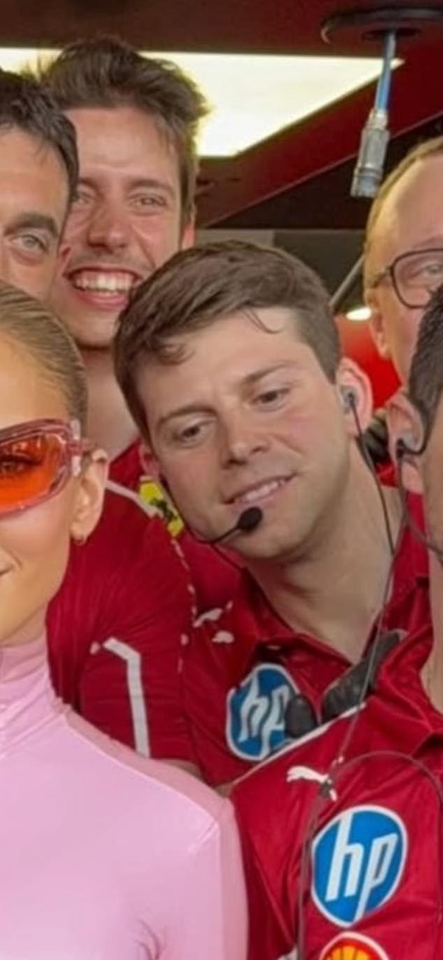 One Ferrari team member appeared distract by the superstar as they posed for a picture