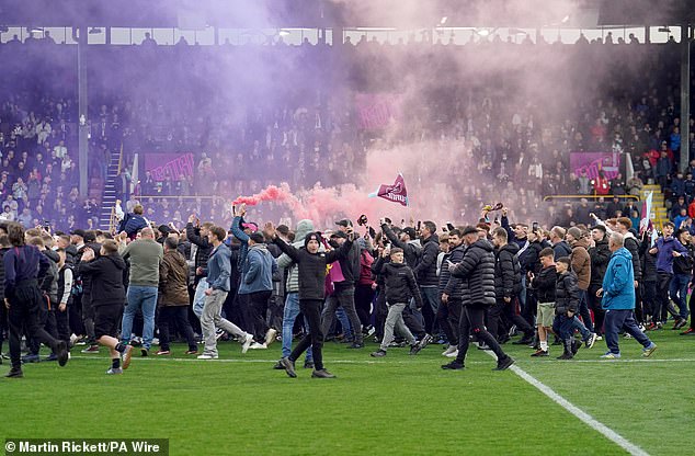 Burnley supporters invaded the pitch after their team's promotion was secured at Turf Moor