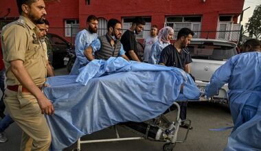Paramedics and police personnel carry an injured tourist at a hospital in Anantnag, south of Srinagar, on April 22, 2025, following an attack
