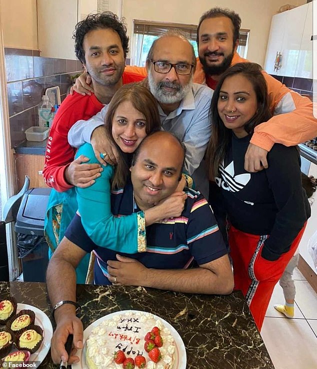 Mirza (pictured with his extended family) was a father of three young children