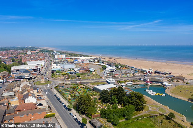 Aerial photo of the town centre of Skegness showing the pier, beach and fairground rides