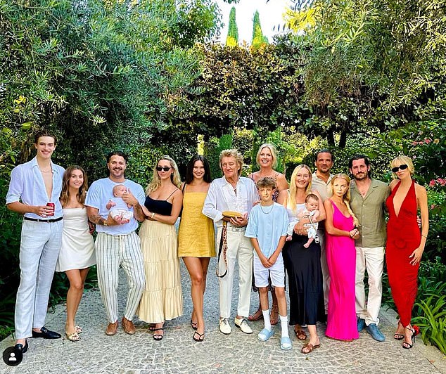 The Maggie May hitmaker, 80, has eight children with five different women, two of whom are sons Alastair, 19, and Aidan, 14, which he raises with third wife Penny, 54 [pictured with seven of his eight children and three grandchildren]