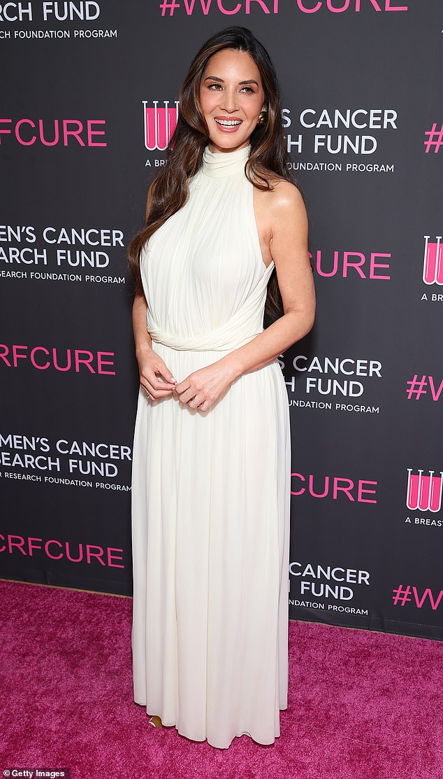 Olivia Munn, 44, stunned in an ivory halterneck dress with soft pleats