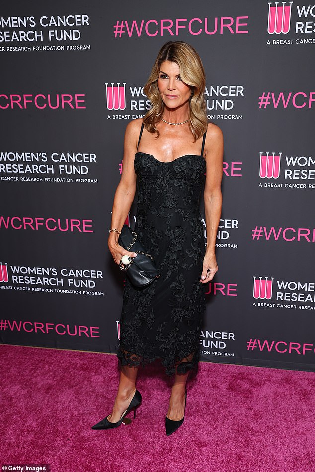 Full House star Lori Loughlin put on a busty display in a black dress with floral stitching