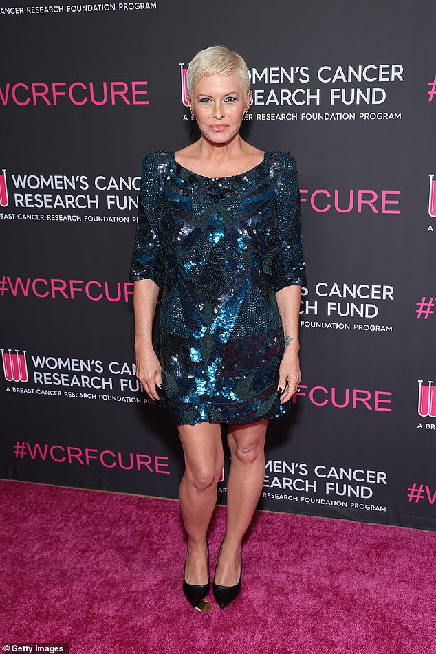 Baywatch star Nicole Eggert rocked a blond pixie cut and a sparkling blue mini dress covered in sequins and beads in jagged patterns
