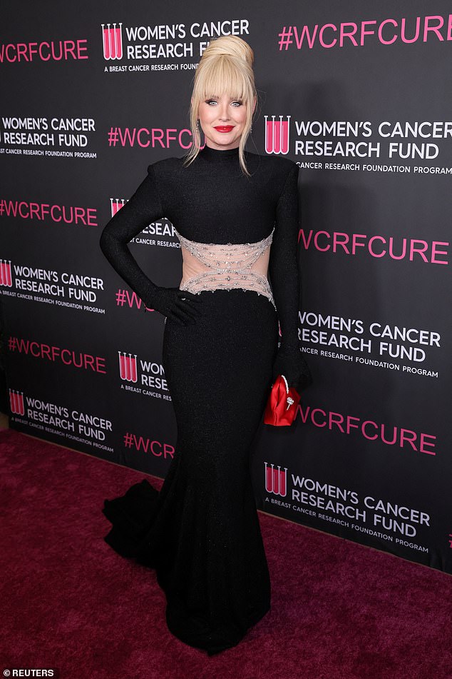 The Melbourne-born star stunned in a black gown that featured a dramatic train and daring sequin detailing across the midriff