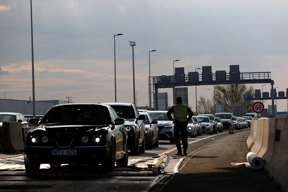 Cars drive through a disinfectant mat during the outbreak of foot-and-mouth disease (REUTERS)