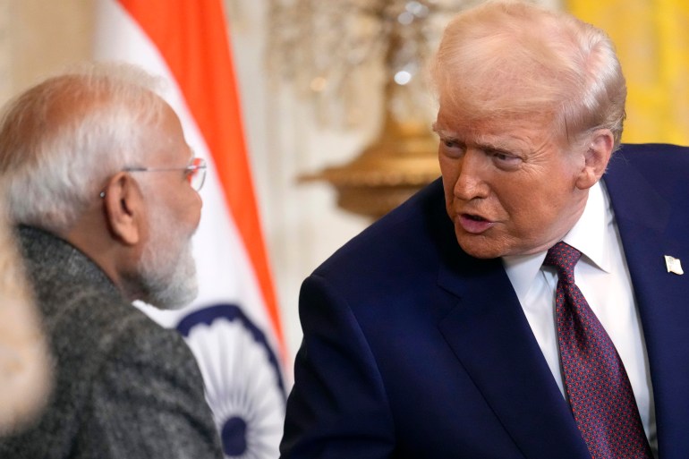 President Donald Trump, right, speaks with India's Prime Minister Narendra Modi during a news conference in the East Room of the White House, Thursday, Feb. 13, 2025, in Washington. (AP Photo/Ben Curtis)