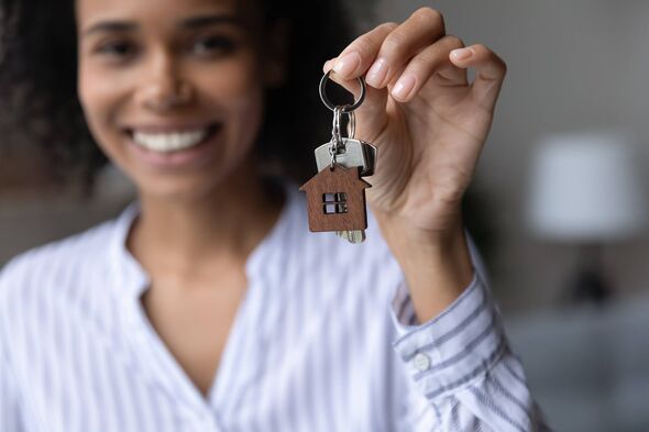 Close up focus on keys in happy woman hand