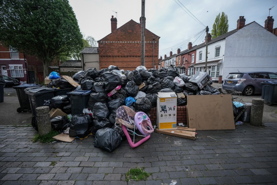 Pile of uncollected rubbish on a residential street during a refuse workers' strike.