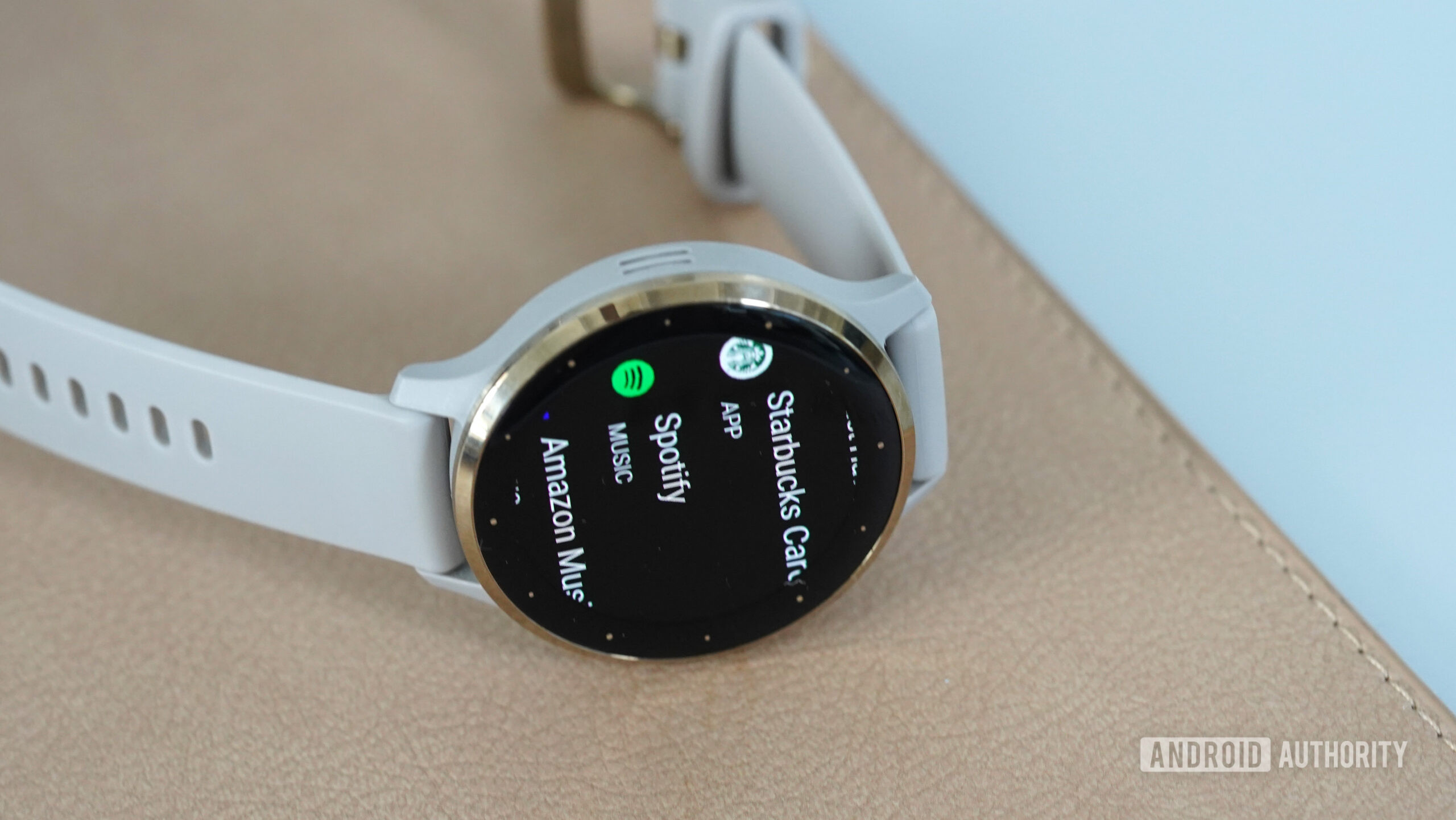A Garmin Venu 3 displays a short app list.
