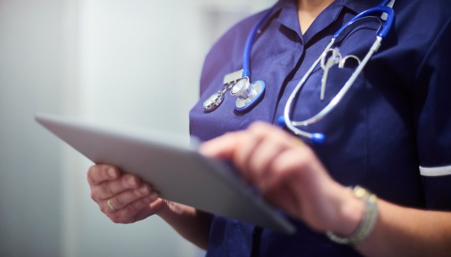 Doctor or surgeon using digital tablet
