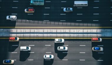 Drone point of view of vehicles on a busy highway.