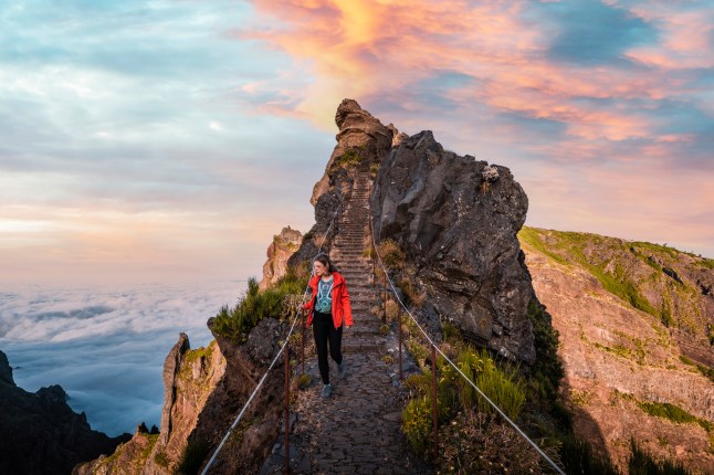 Young woman walking on a scenic mountain trail in Madeira