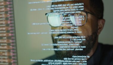 Man studying a see-through display depicting Python computer coding.
