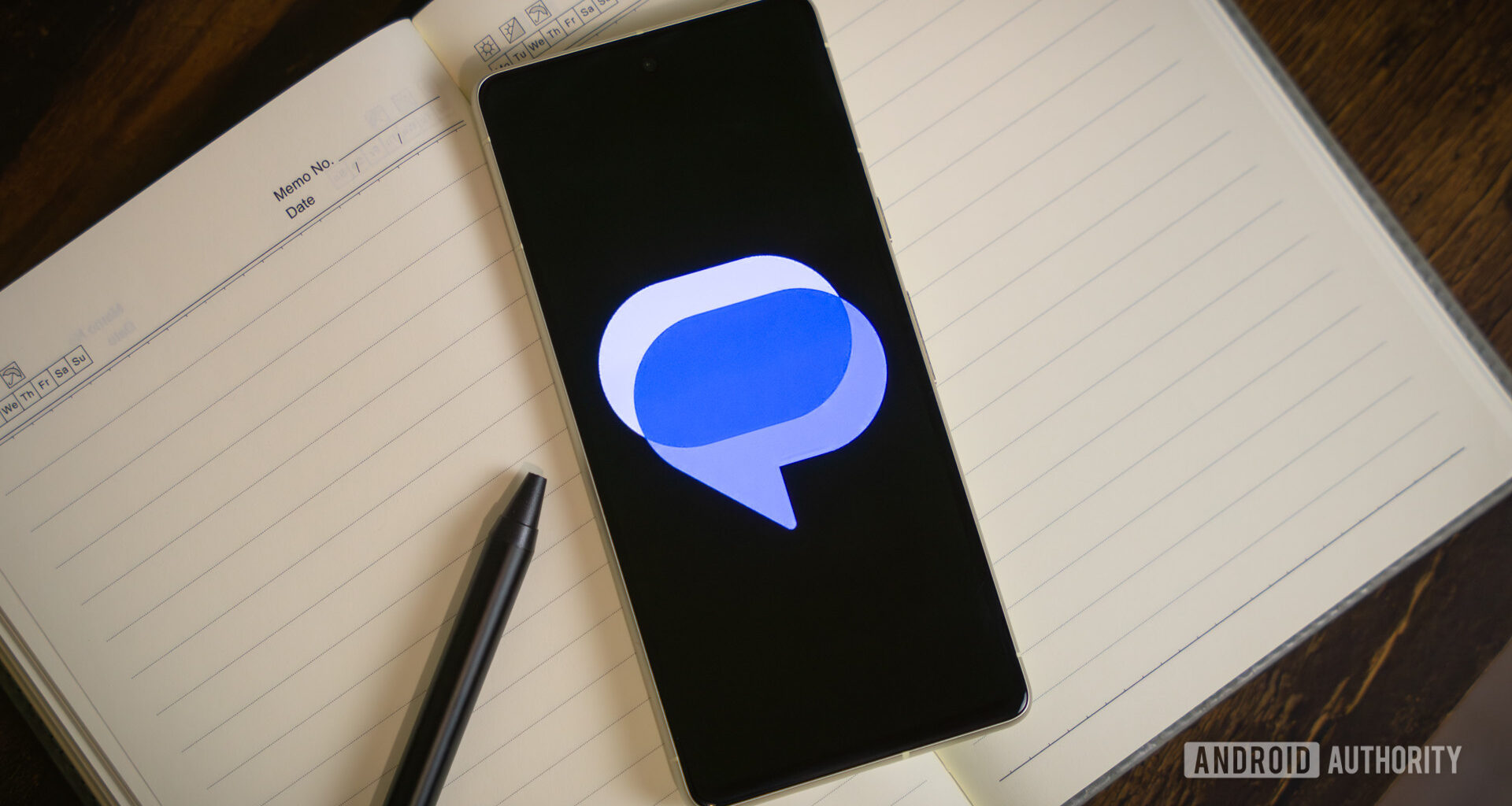 Google Messages logo on smartphone laying on table (4)