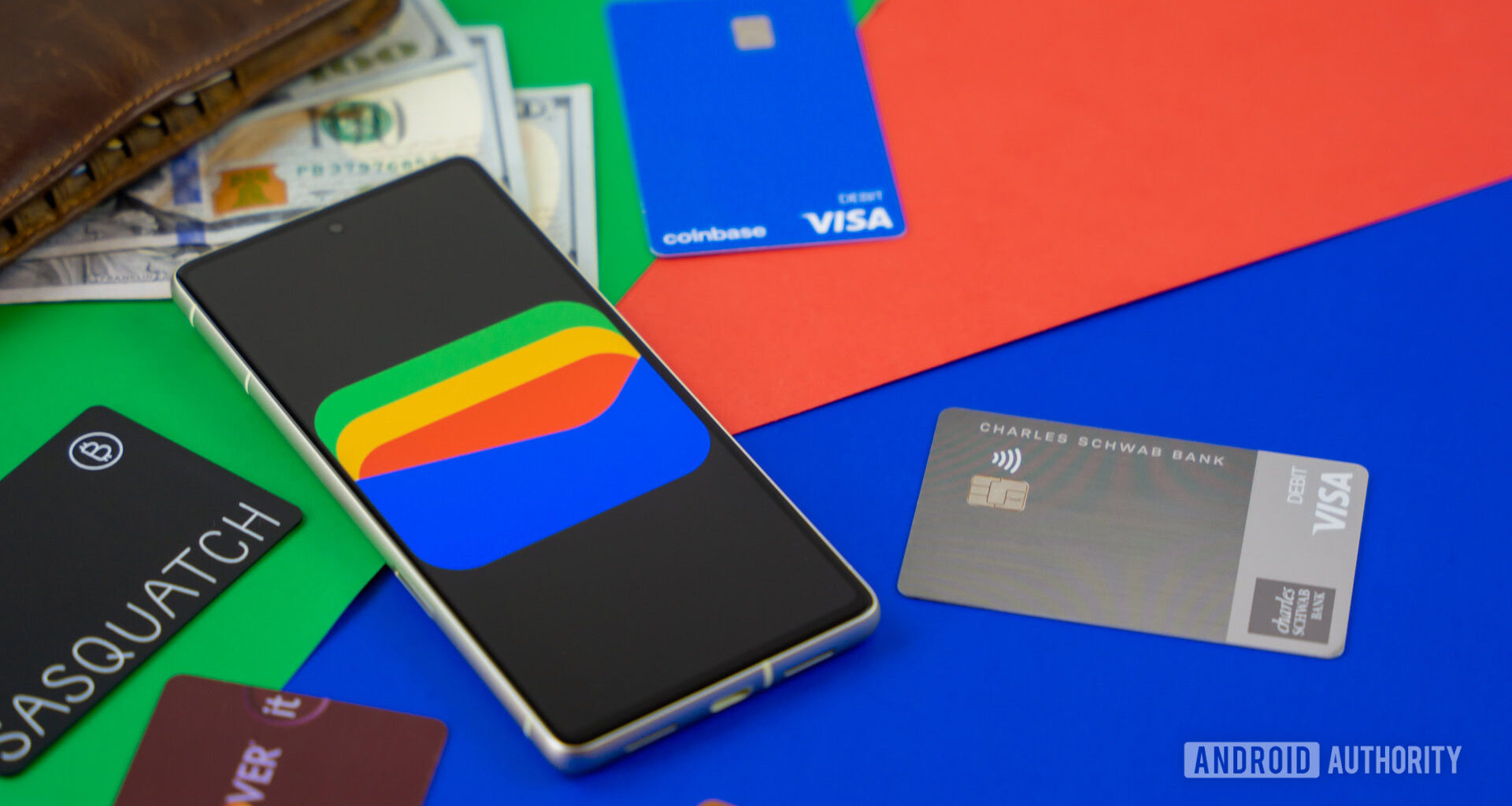 Google Wallet logo on smartphone next to credit cards and cash Stock photo 1
